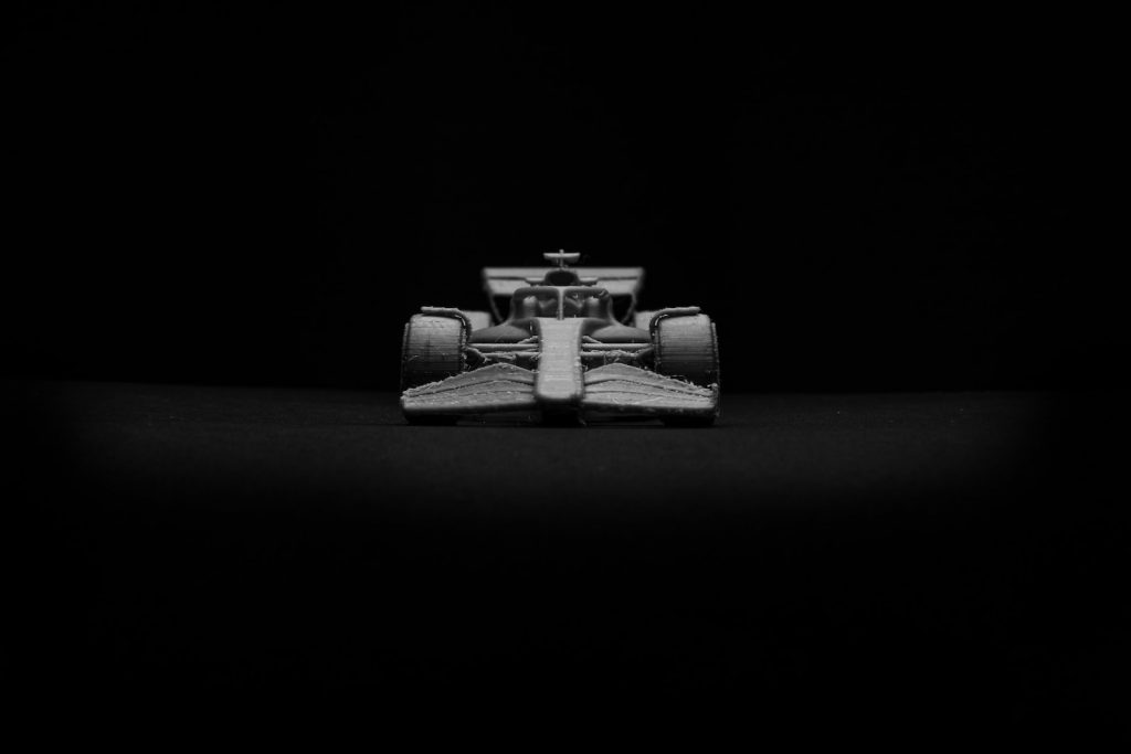 a black and white photo of a racing car